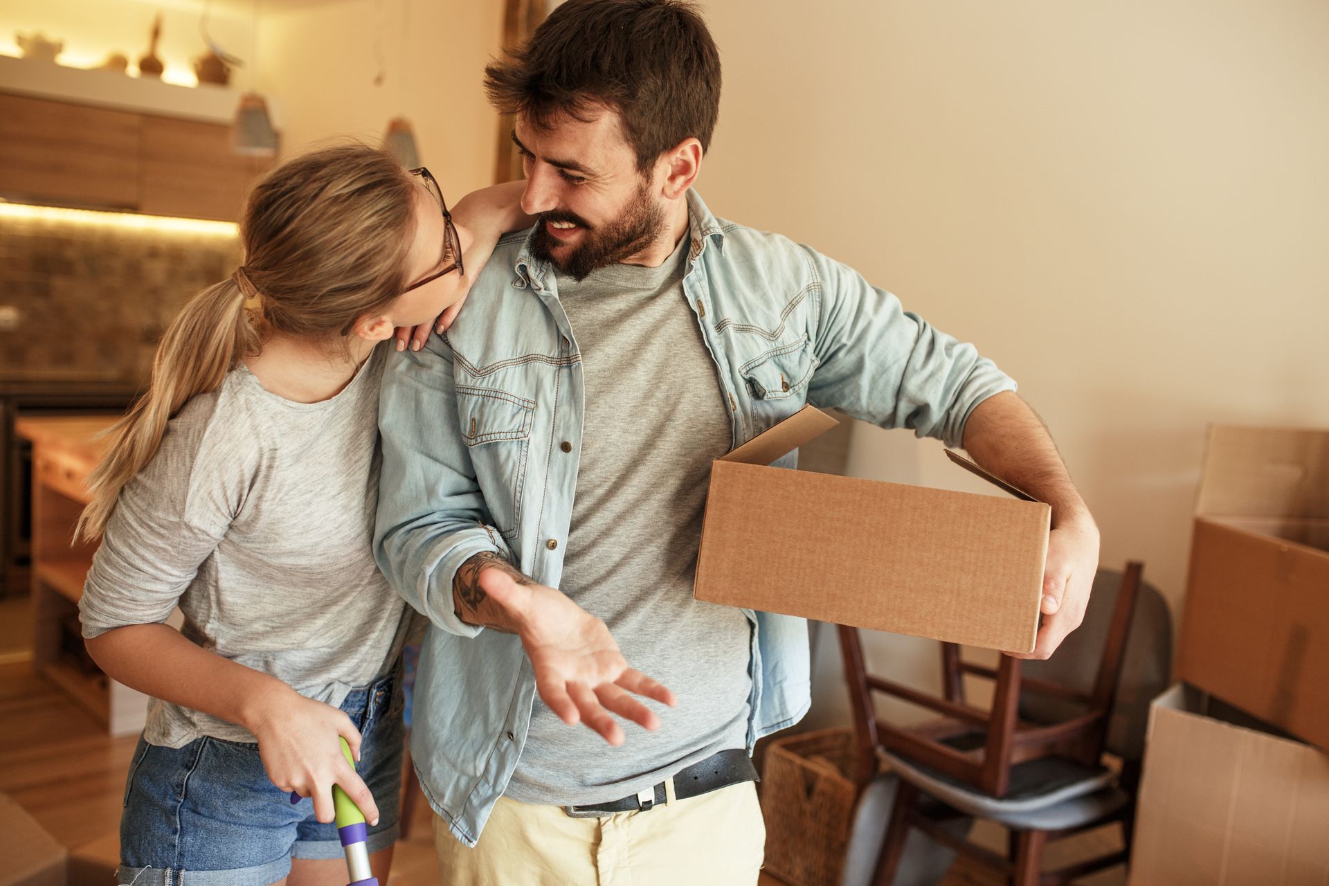 Couple moving into new house.They unpacking  and  cleaning  new home.